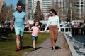 Happy family concept. Parents with son walking in the city. Family taking a walk on street. Young couple walk in city Royalty Free Stock Photo