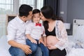 Happy family concept, pregnant mother and father kissing kid boy Royalty Free Stock Photo