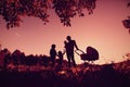 Happy family concept- silhouette of father with tree kids at sunset sky Royalty Free Stock Photo