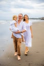 Happy family concept. Summer holidays. Family vacation in Asia. Mother, father and daughter walking barefoot along the beach. Royalty Free Stock Photo