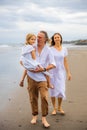 Happy family concept. Summer holidays. Family vacation in Asia. Mother, father and daughter walking barefoot along the beach. Royalty Free Stock Photo