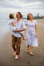 Happy family concept. Summer holidays. Family vacation in Asia. Mother, father and daughter walking barefoot along the beach. Royalty Free Stock Photo