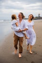 Happy family concept. Summer holidays. Family vacation in Asia. Mother, father and daughter walking barefoot along the beach. Royalty Free Stock Photo