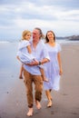 Happy family concept. Summer holidays. Family vacation in Asia. Mother, father and daughter walking barefoot along the beach. Royalty Free Stock Photo