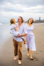 Happy family concept. Summer holidays. Family vacation in Asia. Mother, father and daughter walking barefoot along the beach. Royalty Free Stock Photo