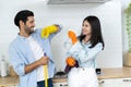 Happy family concept Young happy couple having fun while doing cleaning kitchen Royalty Free Stock Photo