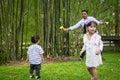 Young father spending time with his children at park during weekend Royalty Free Stock Photo