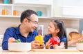 Happy family concepts, Father and daughter cooking together at kitchen, Father is teaching his daugther to cook for breakfast Royalty Free Stock Photo