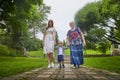 Happy family consisting senior lady grandmother, young mother and small son in garden or park in a summer or autumn