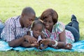 Happy family consulting a mobile phone. Royalty Free Stock Photo