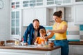 Happy family cooking baking pastry together in kitchen interior mother father and daughter at home. Happy smiling Royalty Free Stock Photo