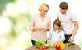 Happy family cooking vegetable salad for dinner Royalty Free Stock Photo