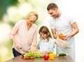 Happy family cooking vegetable salad for dinner Royalty Free Stock Photo