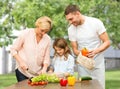 Happy family cooking vegetable salad for dinner Royalty Free Stock Photo