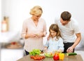 Happy family cooking vegetable salad for dinner Royalty Free Stock Photo