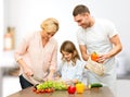 Happy family cooking vegetable salad for dinner Royalty Free Stock Photo