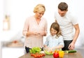 Happy family cooking vegetable salad for dinner Royalty Free Stock Photo