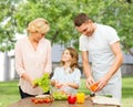 Happy family cooking vegetable salad for dinner Royalty Free Stock Photo