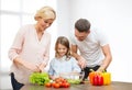 Happy family cooking vegetable salad for dinner Royalty Free Stock Photo