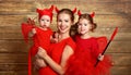 Happy family with costumes devil prepares for Halloween Royalty Free Stock Photo
