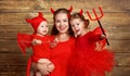 Happy family with costumes devil prepares for Halloween Royalty Free Stock Photo