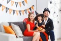 Happy family in costumes getting ready for halloween Royalty Free Stock Photo