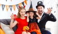 Happy family in costumes getting ready for halloween Royalty Free Stock Photo