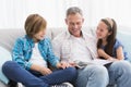 Happy family on the couch reading storybook