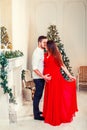 Happy family couple on Christmas at fireplace. Happy couple kiss and hugging Royalty Free Stock Photo