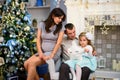 Happy family couple give gifts in the living room, behind the decorated Christmas tree, the light give a cozy atmosphere Royalty Free Stock Photo