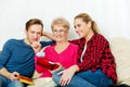 Happy family - couple with old woman who holding gift box and baby shoe Royalty Free Stock Photo