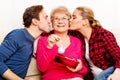 Happy family - couple with old woman who holding gift box and baby shoe Royalty Free Stock Photo