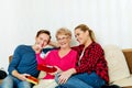 Happy family - couple with old woman who holding gift box and baby shoe Royalty Free Stock Photo
