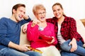 Happy family - couple with old woman who holding gift box and baby shoe Royalty Free Stock Photo