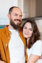 Happy family couple portrait husband and wife in kitchen. Couple of young middle aged man and woman. Young Smiling bald Royalty Free Stock Photo