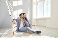 Happy family couple relaxing on floor while doing renovations in their house or apartment Royalty Free Stock Photo