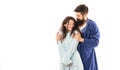 Happy family couple in robes of romantic man hugging sleepy woman in morning, love
