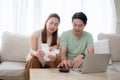 Happy family with couple sitting on sofa calculate finance and expenses of household together in living room at home. Royalty Free Stock Photo