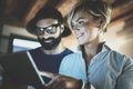 Happy family couple using electronic tablet in livingroom at home.Bearded man in eye glasses making conversation with Royalty Free Stock Photo