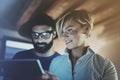 Happy family couple using electronic tablet in livingroom at home.Bearded man in eye glasses making conversation with Royalty Free Stock Photo