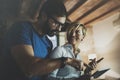 Happy family couple using electronic tablet in livingroom at home.Bearded man in eye glasses making conversation with Royalty Free Stock Photo