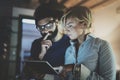 Happy family couple using electronic tablet in livingroom at home.Bearded man in eye glasses making conversation with Royalty Free Stock Photo