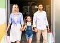 Happy Family Customers Leaving Mall Carrying Shopper Bags Royalty Free Stock Photo