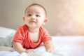 Happy family, Cute Asian newborn baby wear red shirt lying, crawling, play on white bed Royalty Free Stock Photo