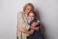 Happy family. Cute grandma and little child girl smiling on grey background