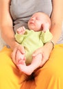 Newborn baby boy sleeping on momÃÂ´s lap Royalty Free Stock Photo