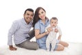 Happy family with cute son sitting on the floor while smiling on Royalty Free Stock Photo