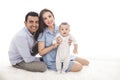 Happy family with cute son sitting on the floor while smiling on Royalty Free Stock Photo