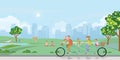 Happy family cycling tandem bicycle in the park on city view background Royalty Free Stock Photo