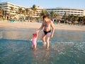 Happy family: dad and child on beach in Persian Gulf ,Dubai Tanning near ocean, tropical resort Royalty Free Stock Photo